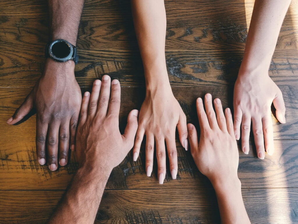 a photo of 5 hands with different skin tones representing diversity